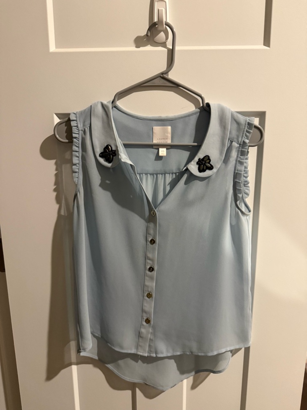 Sleeveless Light Blue Button-Front Blouse with Embellished Collar